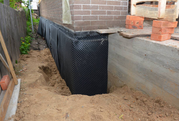 SJ Waterproofing Pros technician performing targeted Basement Waterproofing assessment in Algoma, WI
